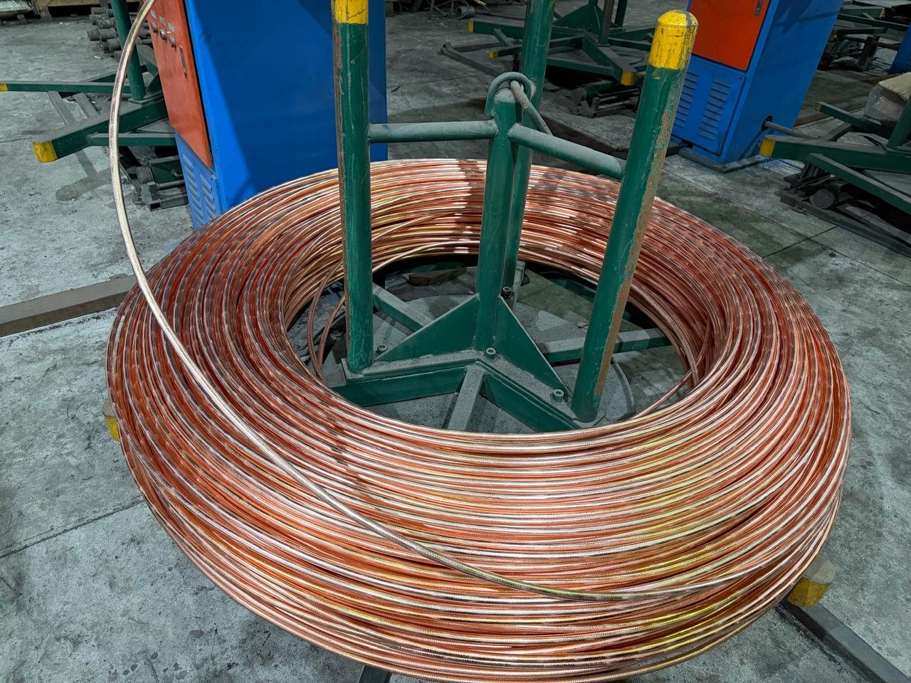 Coil of copper rod on a payoff stand