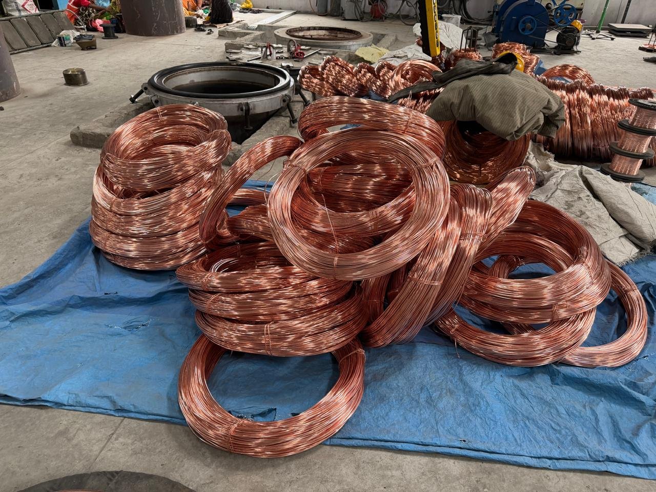 Coils of copper wire scrap laid out on a tarp